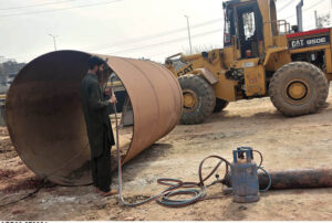 Workers busy welding iron pipe at IJP Road in the Federal Capital.