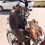 A vendor sharpening the knife on his bicycle setup in the Federal Capital.