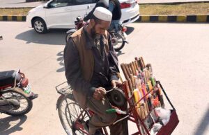 A vendor sharpening the knife on his bicycle setup in the Federal Capital.