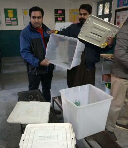 Polling officials showing the empty ballot boxes before start the polling in the polling station during General Election-2024