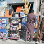 A mechanic busy in repairing ice cream machine at his workplace.