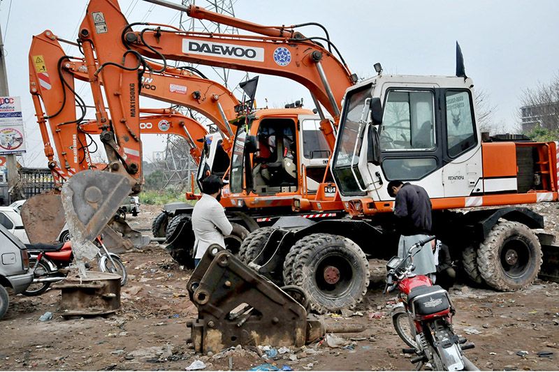 A mechanic reparse an excavator at his work place