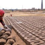Woman Labourer busy preparing bricks at local bricks kiln