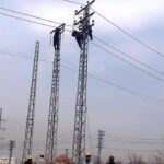 WAPDA workers busy installing new electricity cables on pylons at Chak Shahzad Road in the Federal Capital.