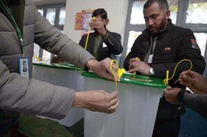 Polling officials showing the empty ballot boxes before start the polling in the polling station during General Election-2024