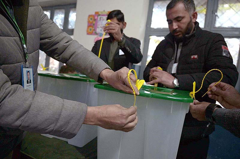 Polling Ballet Polling officials showing the empty ballot boxes before start the ...