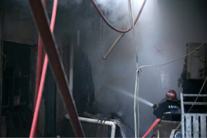 Firefighters struggling to extinguish the fire that erupted in shops at Mughal Sarai Market Raja Bazaar.