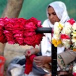 A woman making garland to attract customers at Lakeview Park in the Federal Capital.