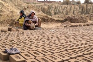 Woman Labourer busy preparing bricks at local bricks kiln