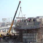 Labourers busy in construction of Abdullah Pur Jhumra Road Flyover during development work in the city.