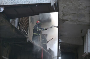 Firefighters struggling to extinguish the fire that erupted in shops at Mughal Sarai Market Raja Bazaar.