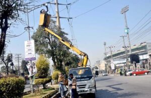 TMA staffer repairing street light during maintenance work in the city.