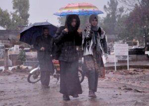 Vehicles passing through rain water accumulated on road at Ghori Town.