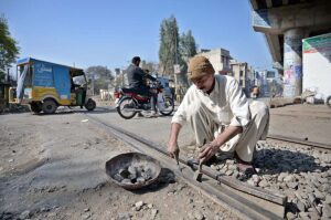  A railway worker clearing railway track to avoid any mishap.