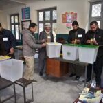 Polling officials showing the empty ballot boxes before start the polling in the polling station during General Election-2024