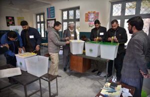 Polling officials showing the empty ballot boxes before start the polling in the polling station during General Election-2024
