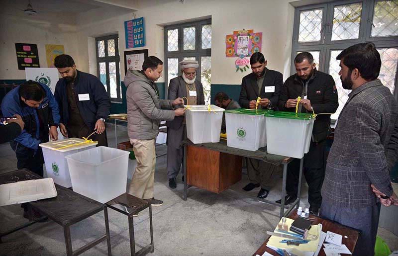 Polling officials showing the empty ballot boxes before start the polling in the polling station during General Election-2024