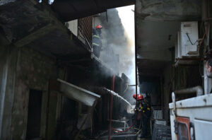 Firefighters struggling to extinguish the fire that erupted in shops at Mughal Sarai Market Raja Bazaar.