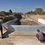 Labourers busy in construction work of bridge on under construction 10th Avenue during development work in Federal Capital.