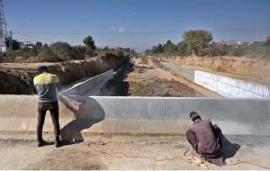Labourers busy in construction work of bridge on under construction 10th Avenue during development work in Federal Capital.
