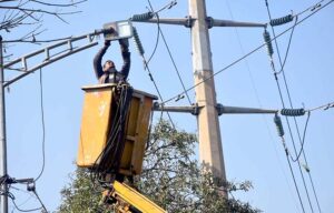 TMA staffer repairing street light during maintenance work in the city.