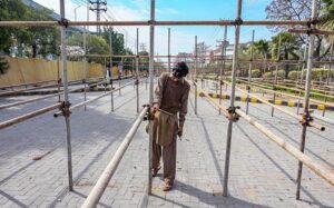 A labouer busy on making way for the spectators to the Pindi Cricket Stadium ahead of planned PSL matches scheduled there. 
