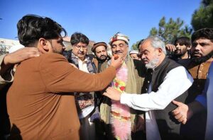 Supporters of independent candidate from PK-82, Peshawar-II, Malik Tariq Awan offering sweets to celebrate his victory in the General Election according to unofficial result.