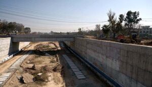 Labourers busy in construction work of bridge on under construction 10th Avenue during development work in Federal Capital.