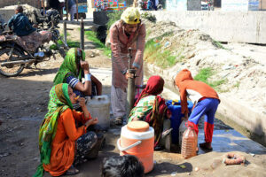 People filling their pots with clean water from hand pump at Hatri area.