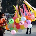 A vendor displayed colorful balloons to attract the customers at roadside.