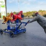 An elderly man on the way pushes a children playing stuff at Moti Mahal.