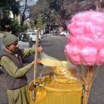 A vendor displaying cotton candy and saltish item to attract the customers in Federal Capital.