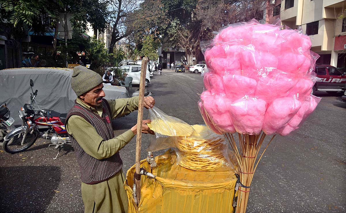 A vendor displaying cotton candy and saltish item to attract the customers in Federal Capital.