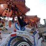 A man busy in decorating a horse-driven carriage at Committee Chowk.