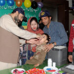 Deputy Commissioner Captain (retired) Rizwan Qadeer is administering Polio Drops to a child during the inauguration of a three-day Anti-Polio Campaign at Shahbaz Sharif Hospital