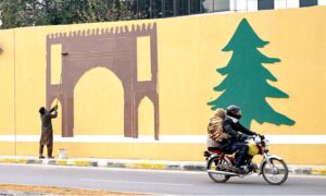 A skilled person paints the wall of 7th Avenue underpass near Aabpara Market