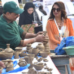 Artisan Making Clay made items on his stall during Faiz Mela at Al-Hamra.