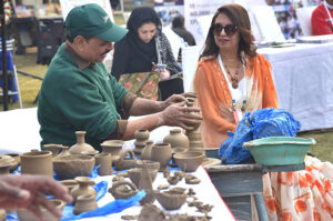 Artisan Making Clay made items on his stall during Faiz Mela at Al-Hamra.
