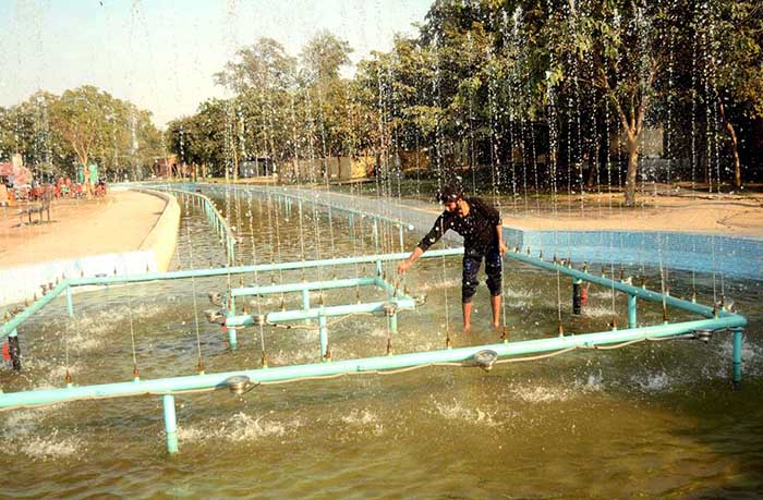 PHA worker repairing fountain at Jilani Park.