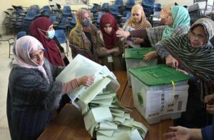 Polling official opens ballot box to count votes at a polling station in F-6 area during General Elections-2024.