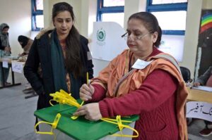 Polling official opens ballot box to count votes at a polling station in F-6 area during General Elections-2024.