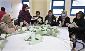 Polling official opens ballot box to count votes at a polling station in F-6 area during General Elections-2024.