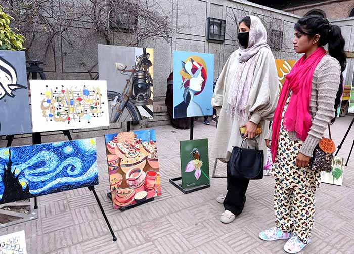 Women viewing artwork during Painting and Calligraphy Exhibition in collaboration with The Formanite School System and Walled City of Lahore Authority.