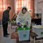 A person casts his vote in the polling station during General Election-2024