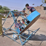 Children enjoying the swing at Qasimabad.