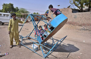 Children enjoying the swing at Qasimabad.