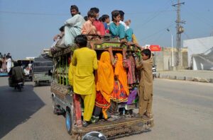 Passengers traveling on the rooftop of Suzuki van in a risky way may cause any mishap and needs the attention of concerned authorities at Hala Naka Road.