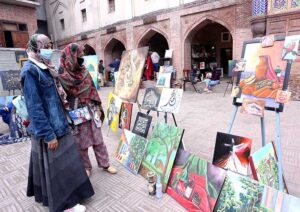 Women viewing artwork during Painting and Calligraphy Exhibition in collaboration with The Formanite School System and Walled City of Lahore Authority.