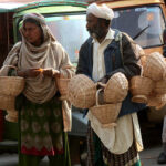 Family displaying and selling handmade baskets to attract the customers.