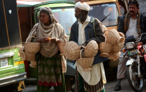 Family displaying and selling handmade baskets to attract the customers.